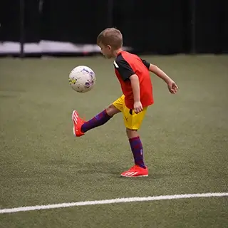 Child Kicking Soccer Ball on the Field | kids football