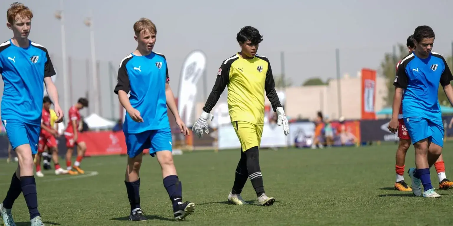 Mina Cup 2024. | A group of young men playing football on a field