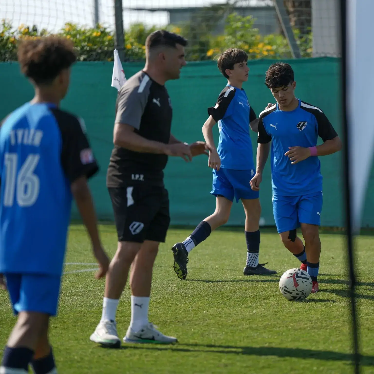 A group of young men playing soccer on a field | Mina Cup 2024.