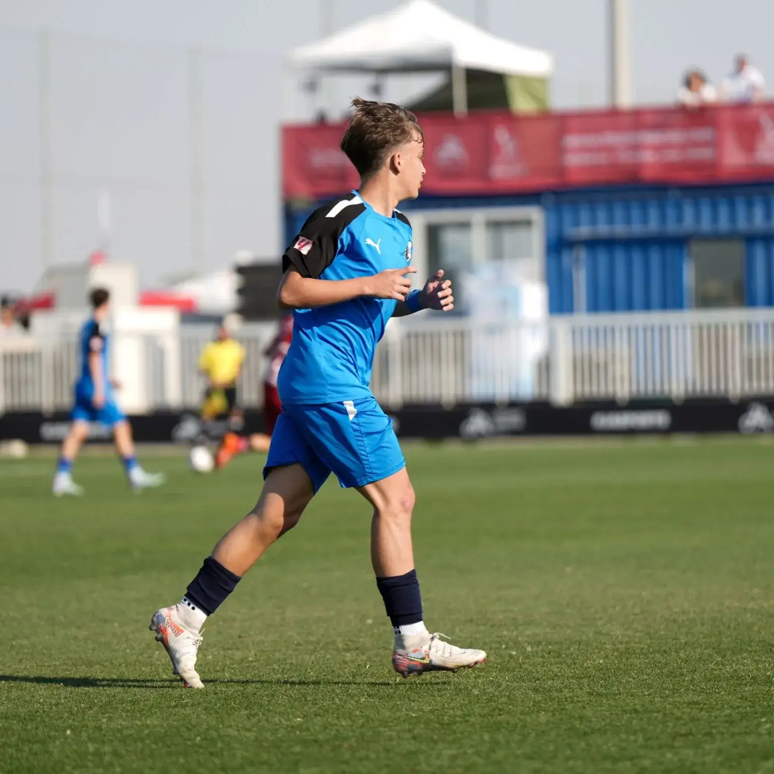 A man sprinting on a soccer field during a match | Mina Cup 2024.