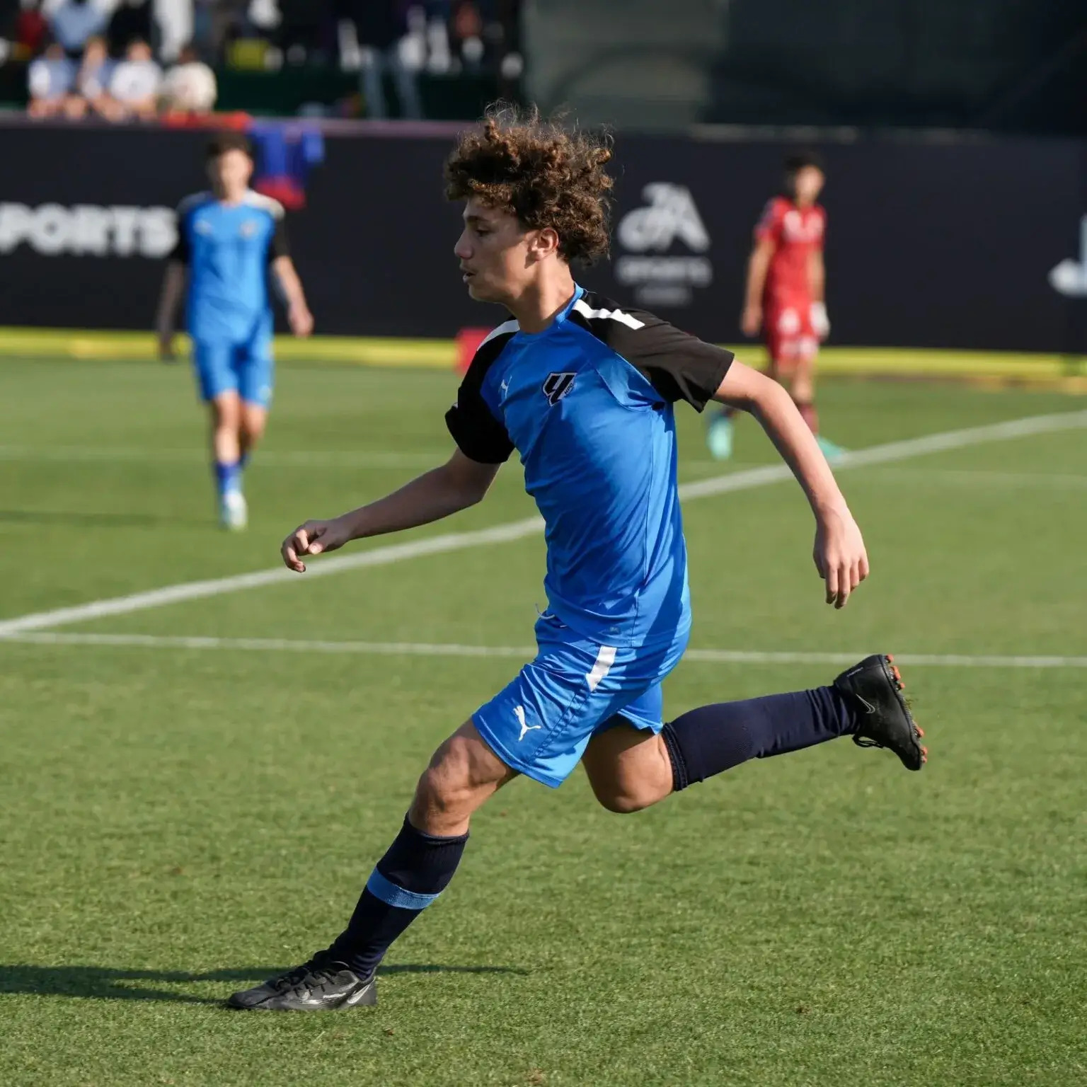 A man sprinting across a soccer field | Mina Cup 2024.