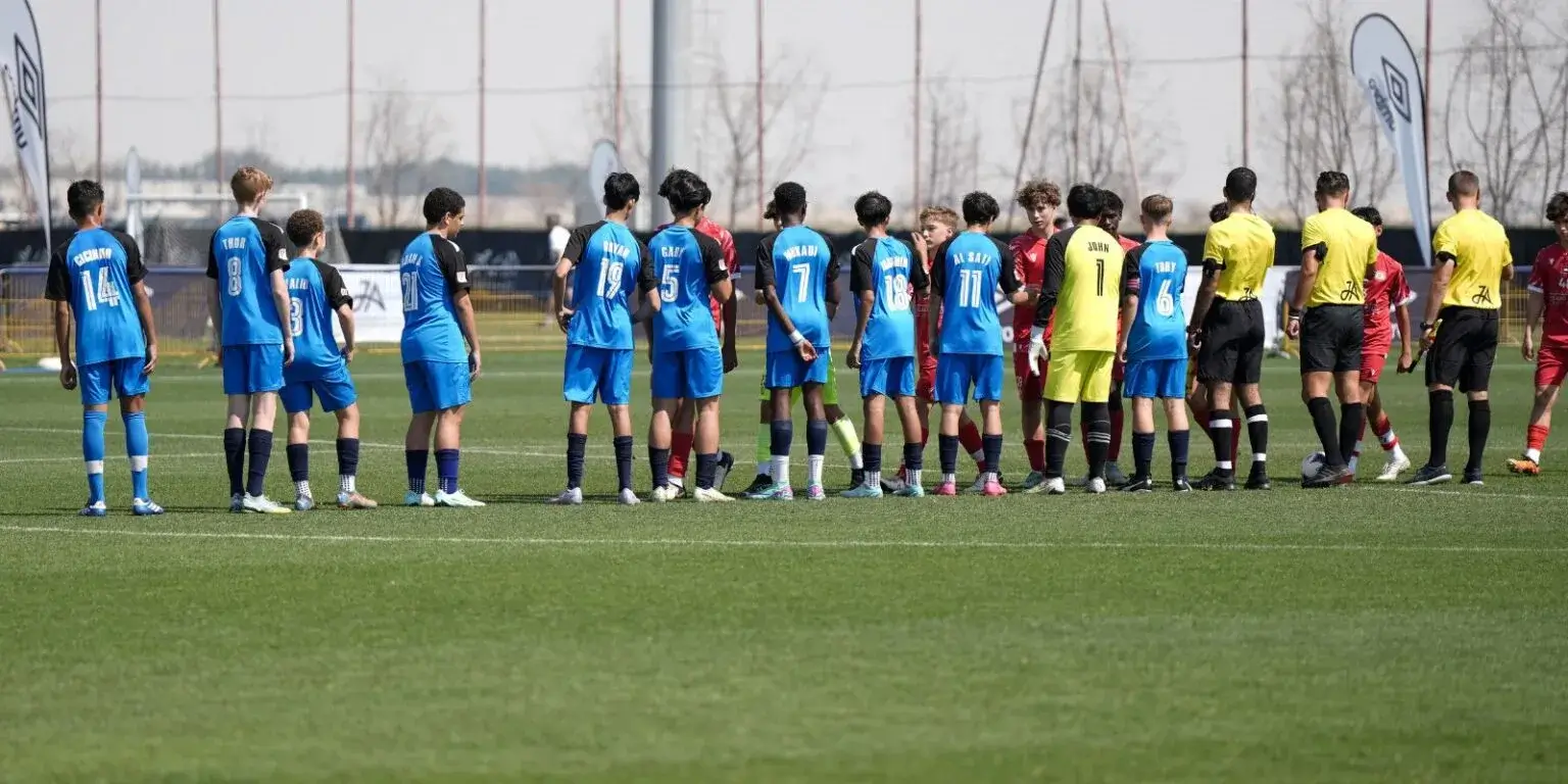 Mina Cup 2024. | A row of soccer players standing on the field