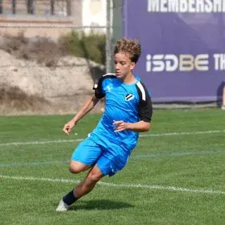 LaLiga Academy Dubai Open Trials | A young man in blue chasing a soccer ball.