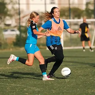 Girls Playing Football Together on a Green Field | Girls Football