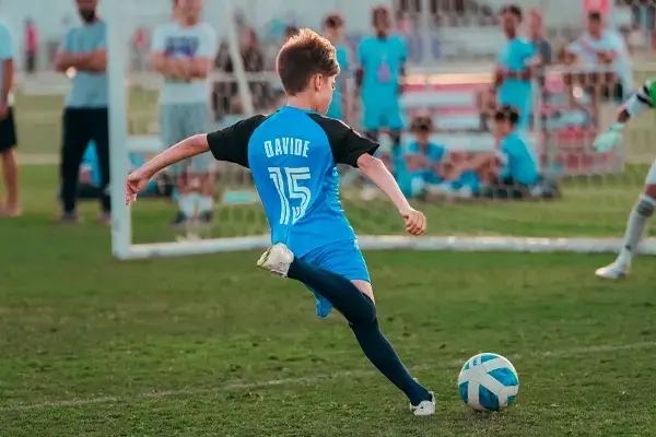 Young Boy Practicing Soccer Skills at Advanced Football Academy