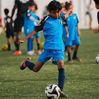 Young Boy Engaged in Kids Football | Soccer Kick